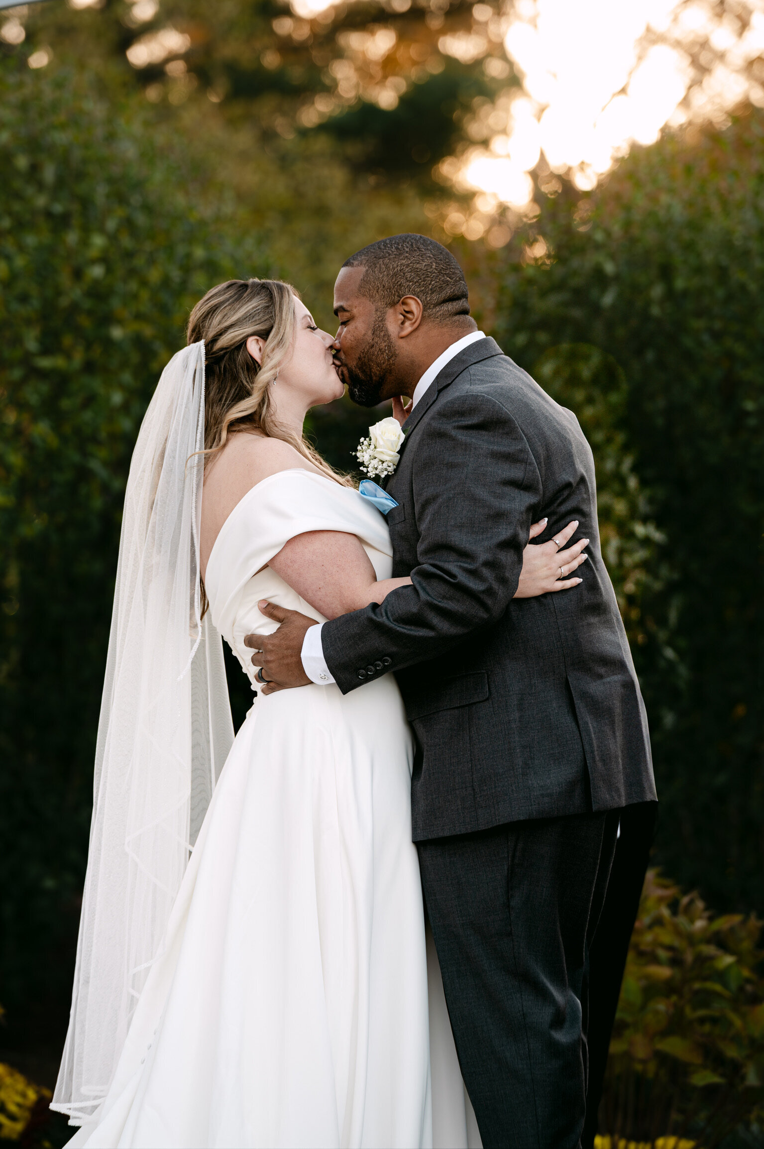 Couple toasting at a small table in the vineyard