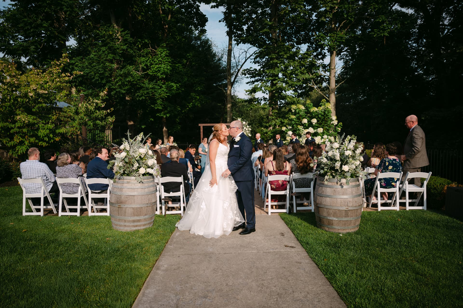 Couple kissing at the end of the aisle after their outdoor ceremony