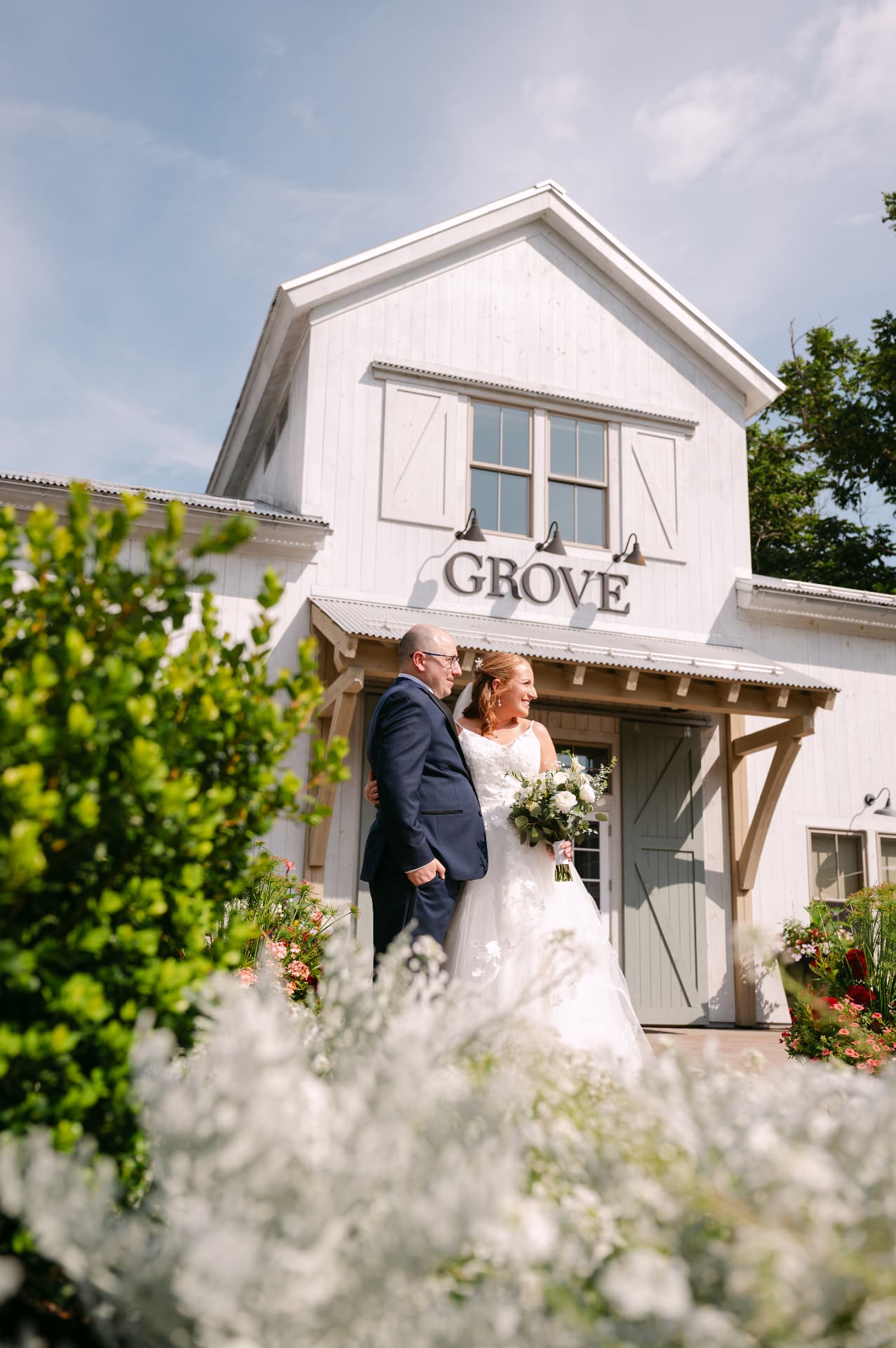Bride and groom outside the Grove barn on their wedding day