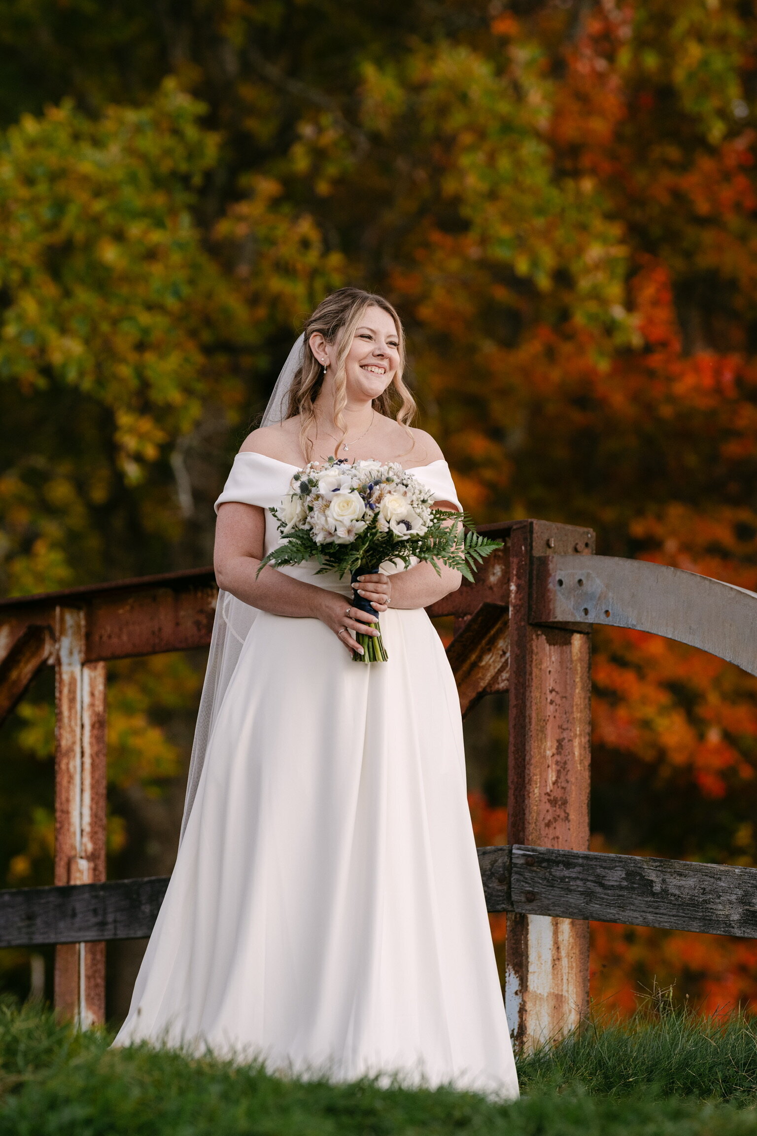 Bride in an autumn field of orange leaves